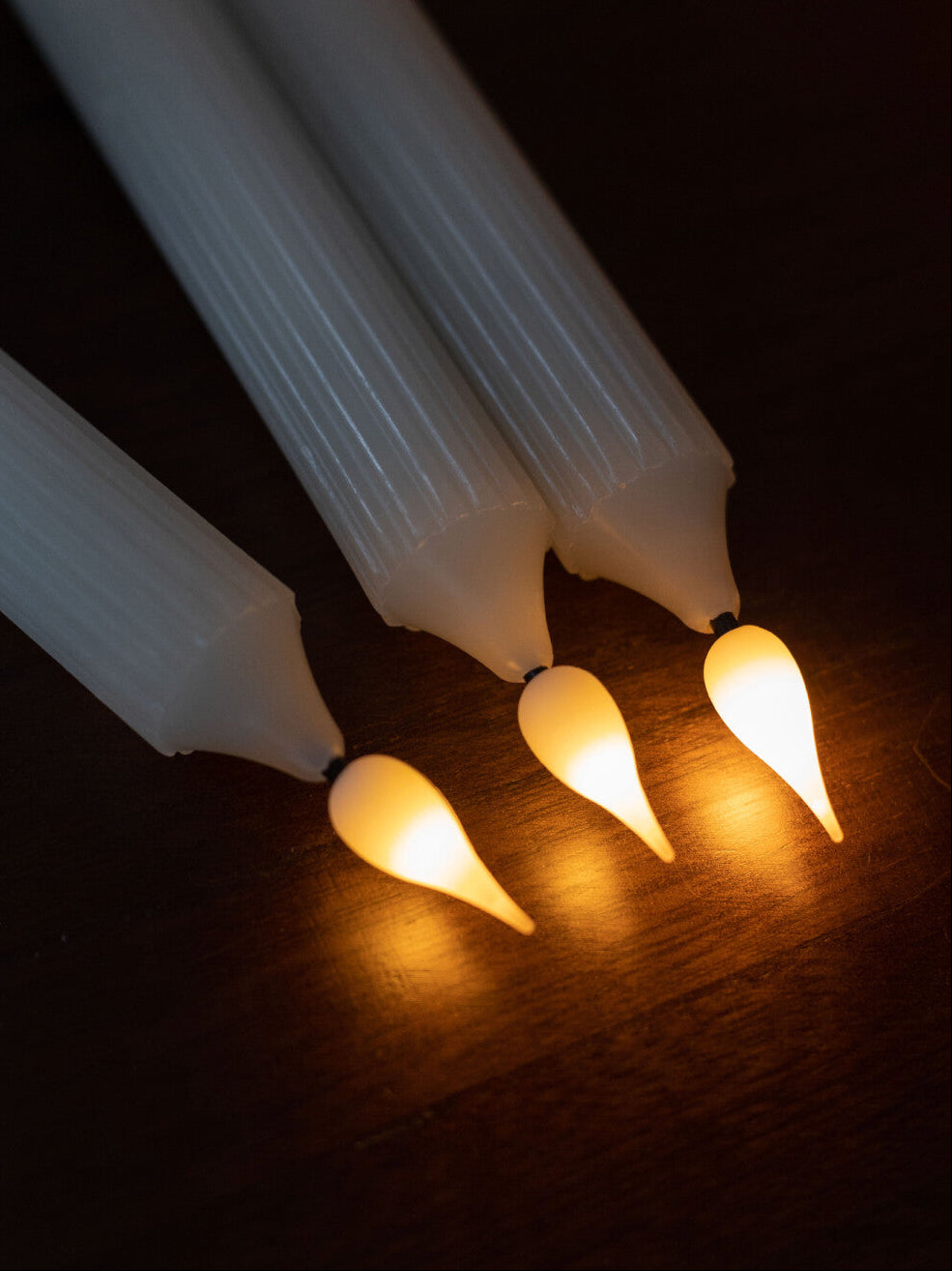 String of lights with glowing bulbs on a dark surface